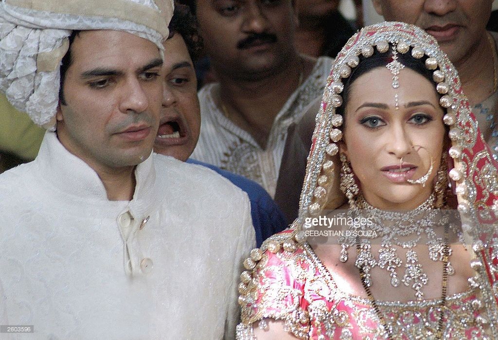 Indian film actress Karishma Kapoor (R) and her new husband Sanjay - Karishma Kapoor’s Husband: Sanjay Kapoor, the Bollywood Power Couple